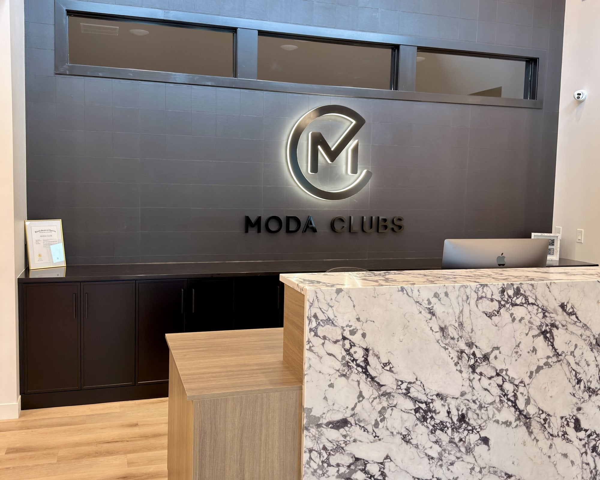 Moda Clubs reception in Sioux Falls with an illuminated Circle M wall logo