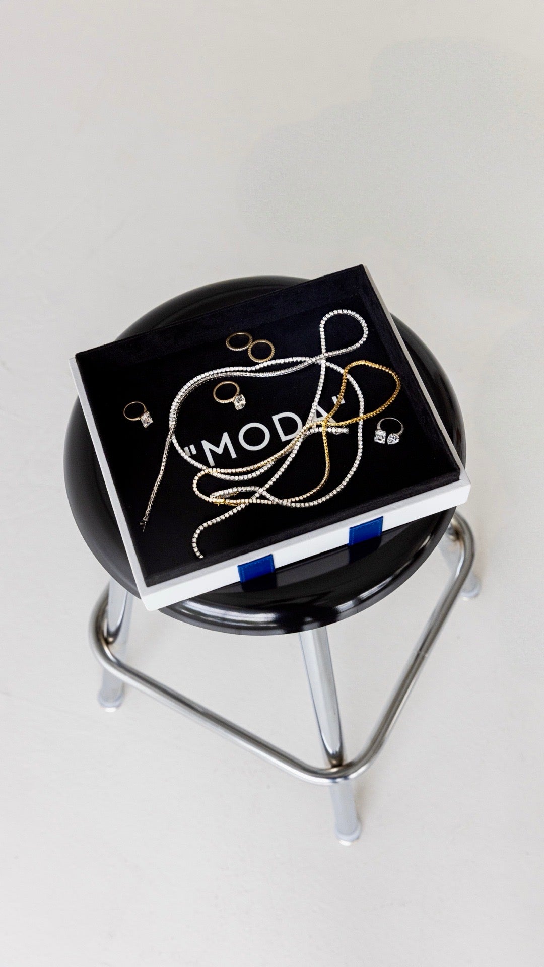 Fine jewelry arranged on a black MODA tray